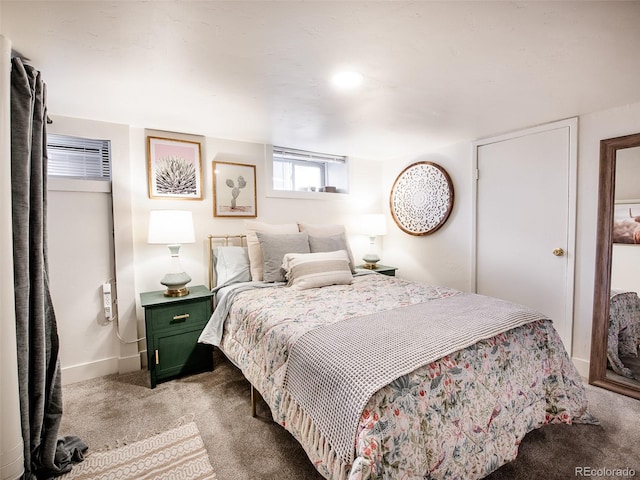 carpeted bedroom featuring baseboards