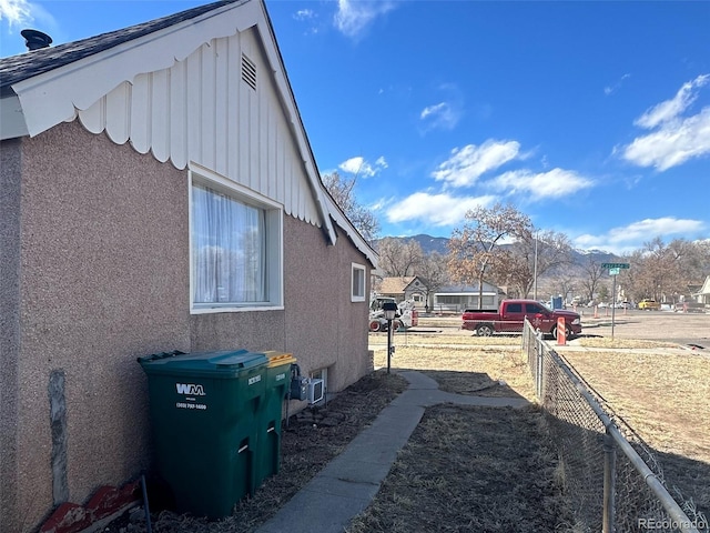 view of home's exterior featuring fence and stucco siding