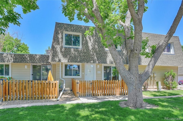 6885 E Arizona Ave Unit D, Denver, CO 80224 - view of front facade featuring roof with shingles and a fenced front yard