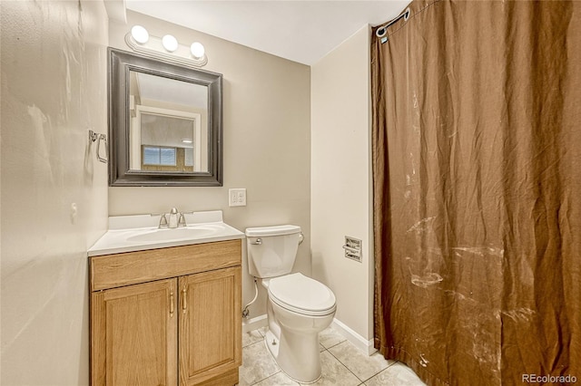 bathroom featuring toilet, vanity, and tile patterned floors