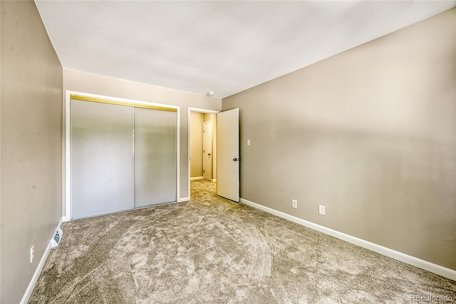 unfurnished bedroom featuring carpet flooring and a closet