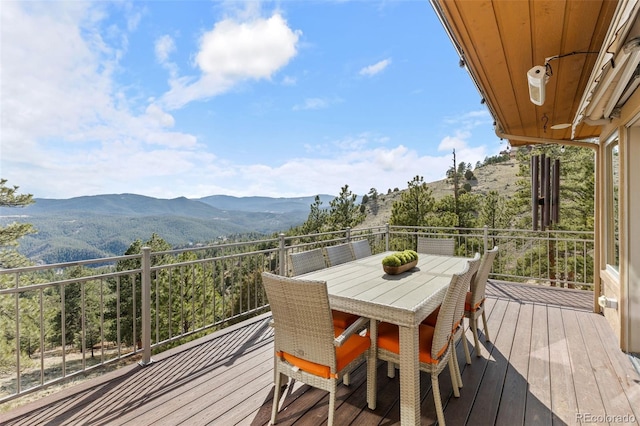 deck featuring a mountain view and outdoor dining area