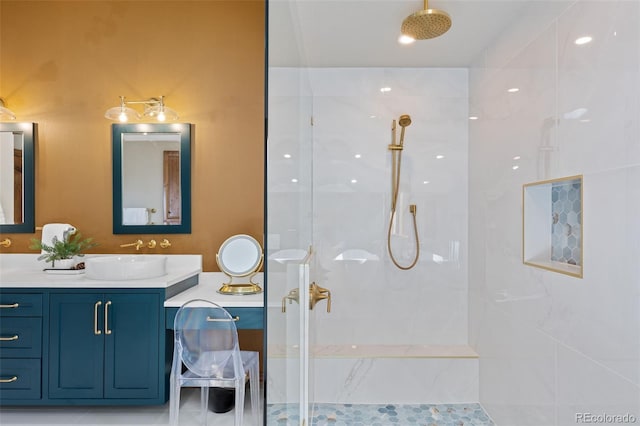 bathroom with a walk in shower and vanity