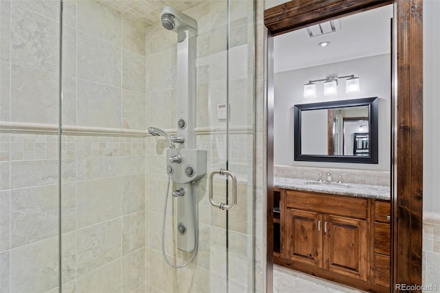bathroom with vanity and a shower stall