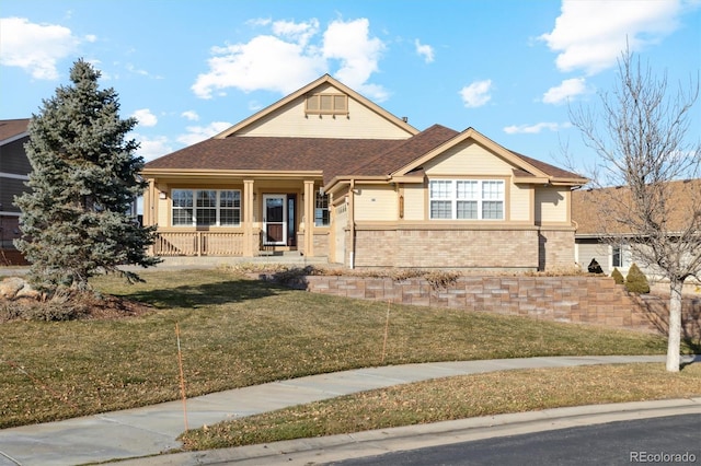 view of front facade featuring covered porch and a front lawn