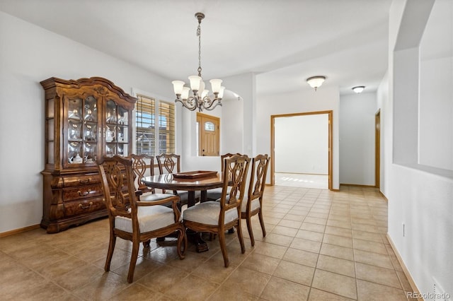 dining room with light tile patterned floors and a chandelier