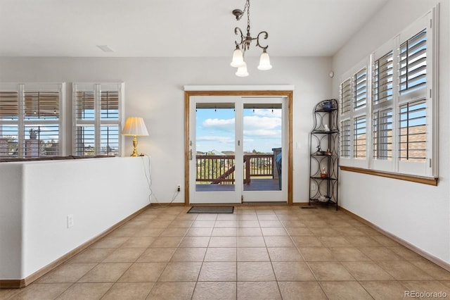 entryway featuring a notable chandelier and light tile patterned floors