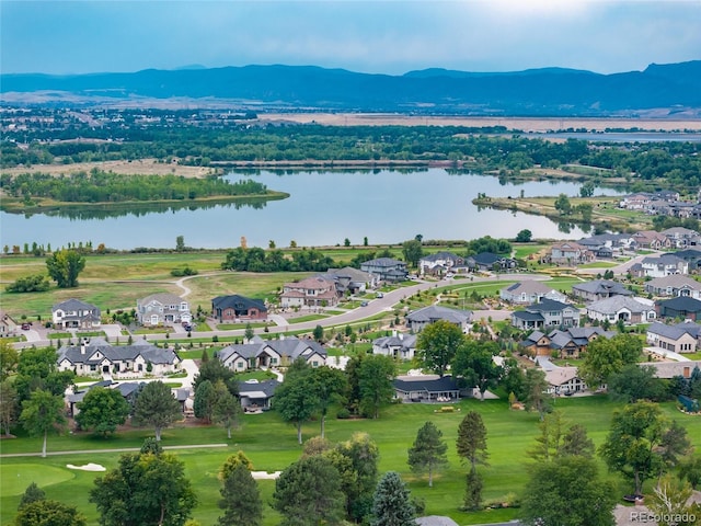 birds eye view of property with a water and mountain view