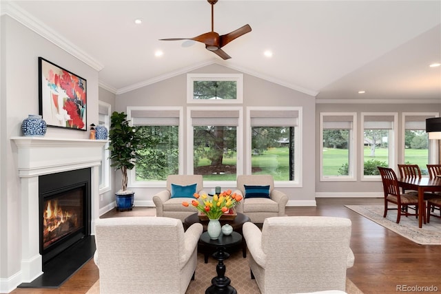 living room featuring lofted ceiling, hardwood / wood-style flooring, a wealth of natural light, and crown molding