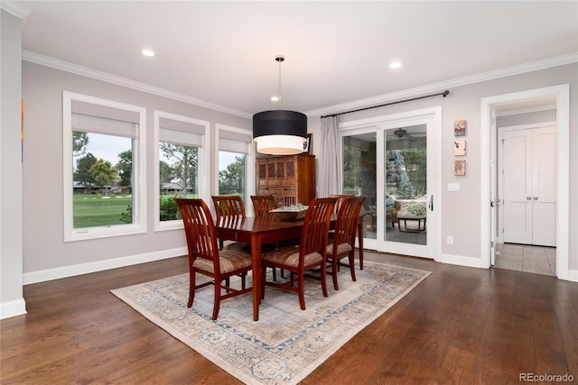 dining space featuring dark wood-type flooring and ornamental molding