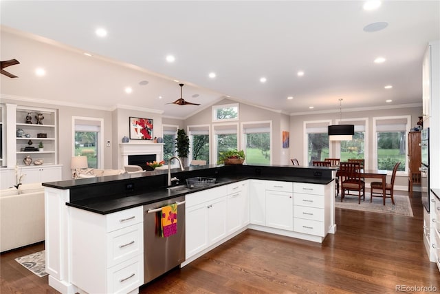 kitchen with white cabinetry, hanging light fixtures, a center island with sink, and appliances with stainless steel finishes