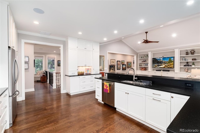 kitchen with lofted ceiling, sink, white cabinets, stainless steel appliances, and dark wood-type flooring