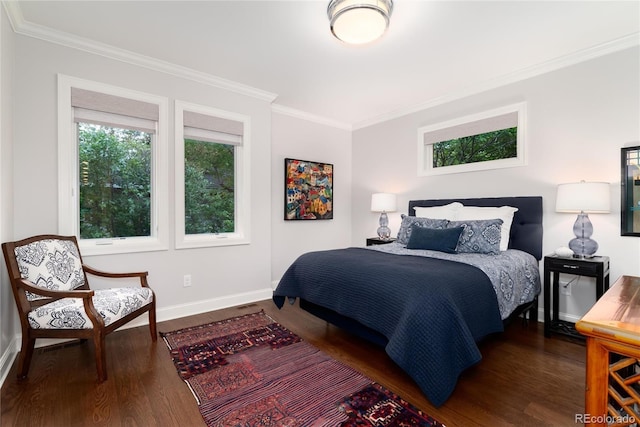 bedroom with multiple windows, dark hardwood / wood-style flooring, and ornamental molding