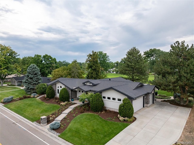 single story home featuring a garage and a front yard