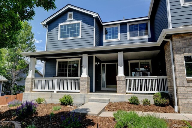 879 Quintana Ln, Erie, CO 80516 - view of front of house featuring a porch