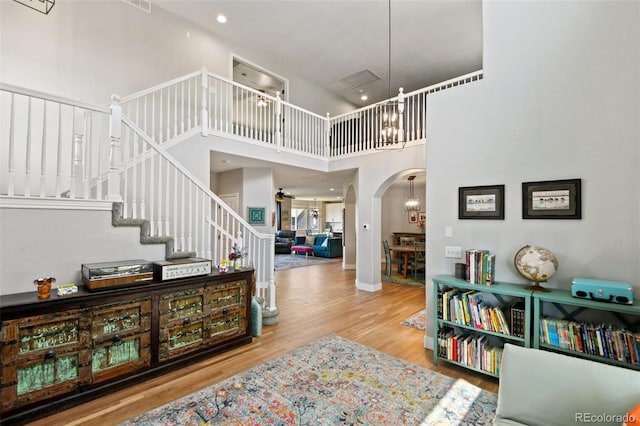 879 Quintana Ln, Erie, CO 80516 - entryway with arched walkways, wood finished floors, a high ceiling, and stairway