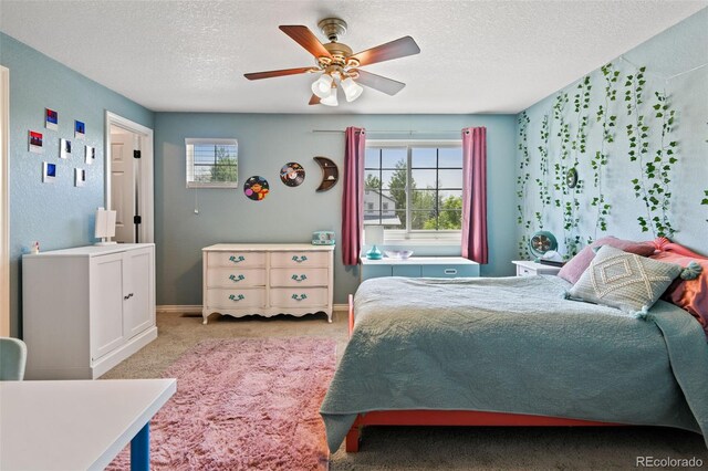 879 Quintana Ln, Erie, CO 80516 - carpeted bedroom with a textured ceiling, multiple windows, ceiling fan, and baseboards