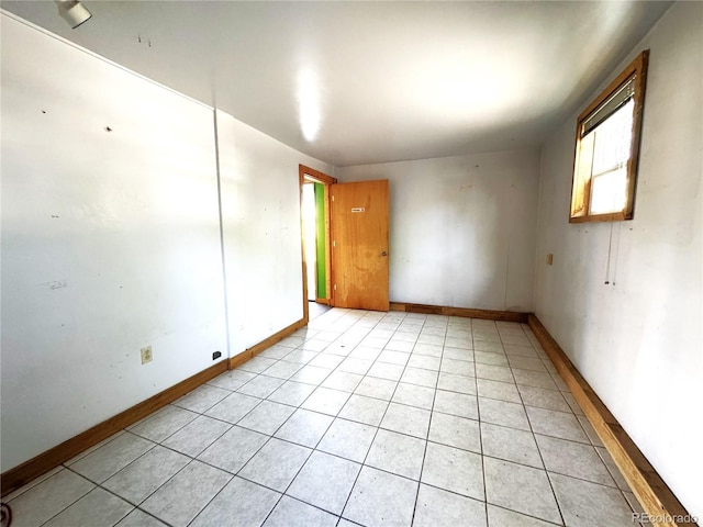 211 Oak St, Salida, CO 81201 - empty room with healthy amount of natural light, light tile patterned floors, and baseboards