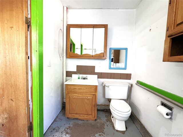 211 Oak St, Salida, CO 81201 - bathroom featuring toilet, vanity, and concrete floors