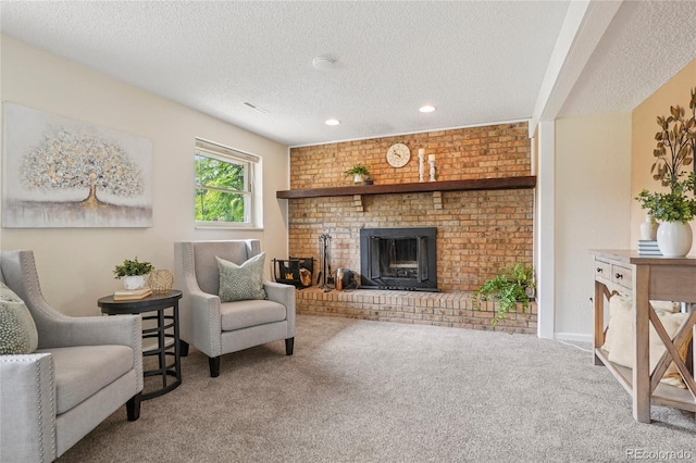 2173 S Ouray St, Aurora, CO 80013 - carpeted living room featuring a textured ceiling, a brick fireplace, and recessed lighting