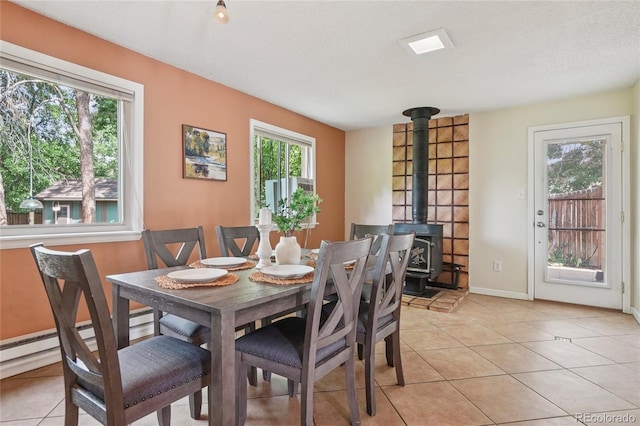 2173 S Ouray St, Aurora, CO 80013 - dining area with a wood stove and light tile patterned flooring