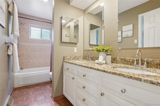 2173 S Ouray St, Aurora, CO 80013 - full bathroom featuring double vanity, shower / bath combination, and a textured wall