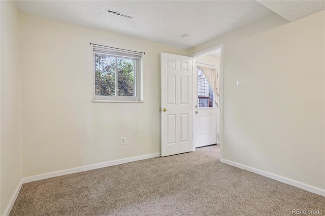 2173 S Ouray St, Aurora, CO 80013 - spare room with carpet floors, a textured ceiling, and a smoke detector
