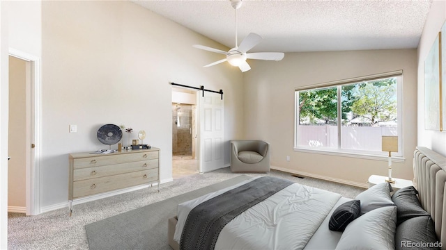 carpeted bedroom featuring a barn door, lofted ceiling, radiator heating unit, a textured ceiling, and ensuite bathroom