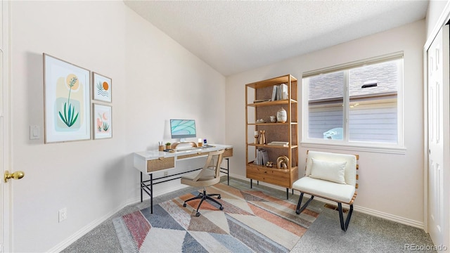 office area with baseboards, carpet, vaulted ceiling, and a textured ceiling