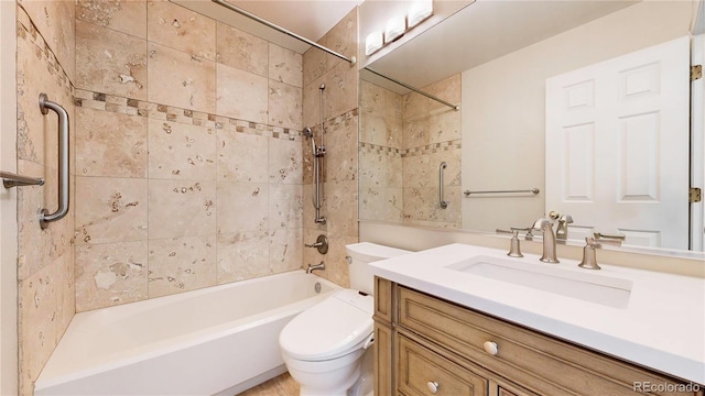 bathroom with bathing tub / shower combination, toilet, and vanity