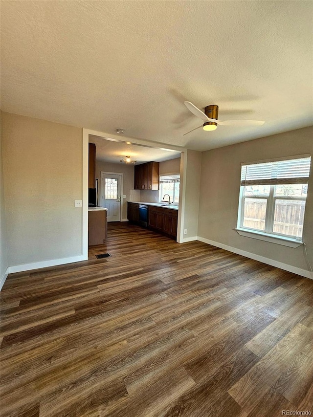 1435 N Uinta St, Denver, CO 80220 - unfurnished living room with dark wood-style floors, a textured ceiling, baseboards, ceiling fan, and a sink