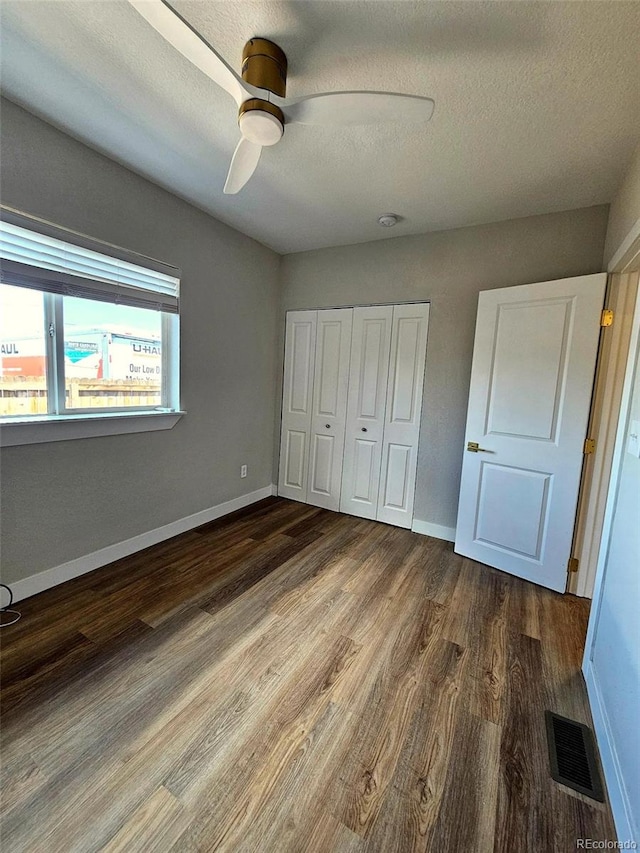 1435 N Uinta St, Denver, CO 80220 - unfurnished bedroom featuring wood finished floors, baseboards, a closet, and a textured ceiling
