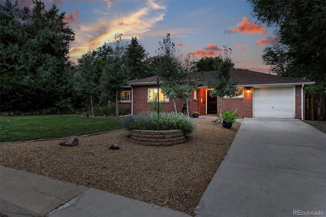 4465 Zephyr St, Wheat Ridge, CO 80033 - ranch-style home with concrete driveway, brick siding, and an attached garage