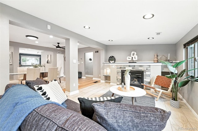 4465 Zephyr St, Wheat Ridge, CO 80033 - living area with a glass covered fireplace, recessed lighting, and a ceiling fan