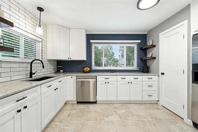 4465 Zephyr St, Wheat Ridge, CO 80033 - kitchen featuring stainless steel dishwasher, decorative backsplash, white cabinetry, pendant lighting, and light stone counters