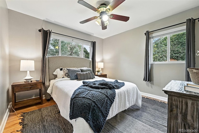 4465 Zephyr St, Wheat Ridge, CO 80033 - bedroom with multiple windows, wood finished floors, and a ceiling fan