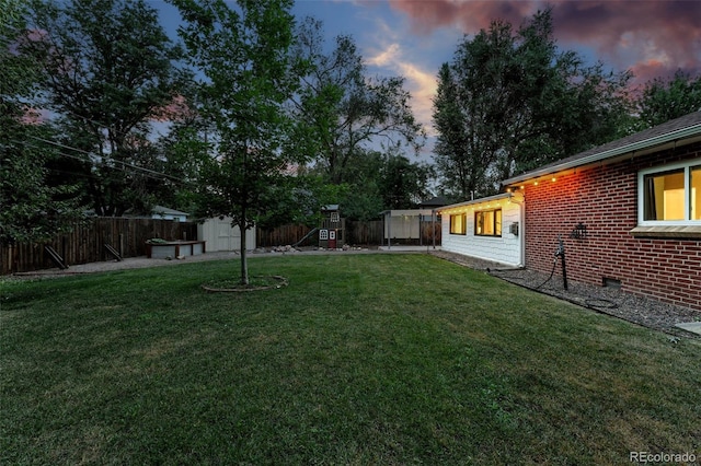 4465 Zephyr St, Wheat Ridge, CO 80033 - yard at dusk with a shed and a fenced backyard