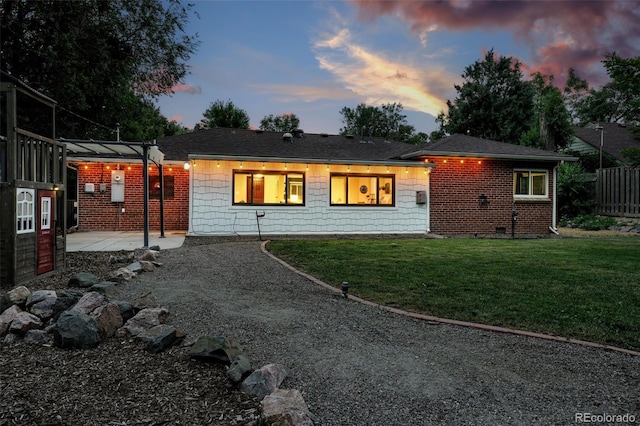 4465 Zephyr St, Wheat Ridge, CO 80033 - back of property featuring a yard, gravel driveway, and a patio area