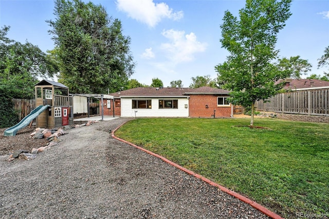 4465 Zephyr St, Wheat Ridge, CO 80033 - back of house featuring brick siding, a playground, and gravel driveway