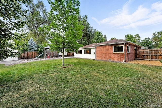 4465 Zephyr St, Wheat Ridge, CO 80033 - fenced backyard featuring a playground