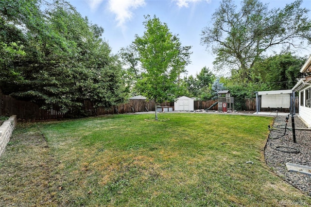 4465 Zephyr St, Wheat Ridge, CO 80033 - fenced backyard featuring a storage shed and a playground