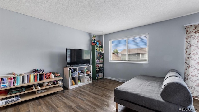 living room featuring dark hardwood / wood-style floors and a textured ceiling