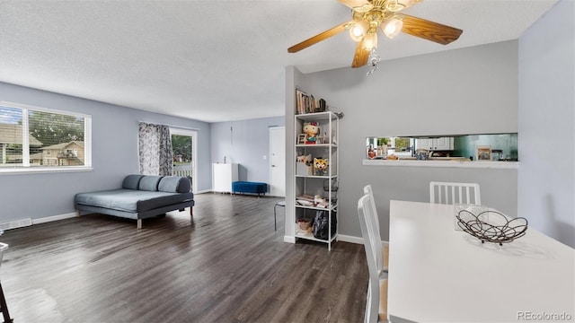 dining room with ceiling fan, dark wood-type flooring, and a textured ceiling