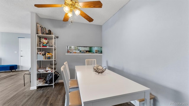 dining room with hardwood / wood-style floors, a textured ceiling, and ceiling fan