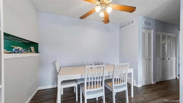 dining area featuring a textured ceiling, dark hardwood / wood-style flooring, and ceiling fan