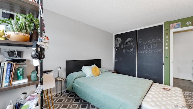 bedroom with a textured ceiling and a closet