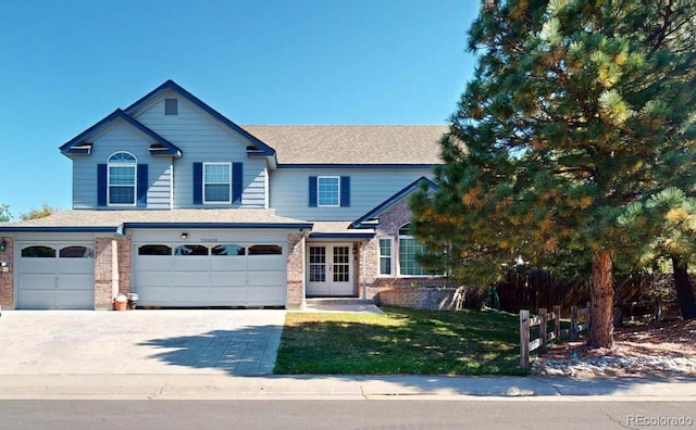 view of front of house with a garage and a front yard