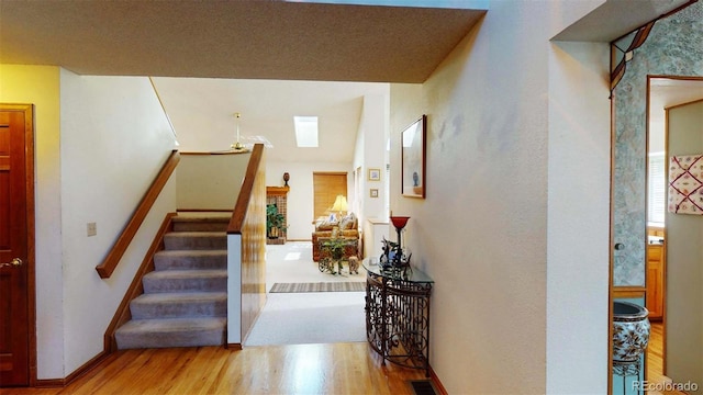 interior space with wood-type flooring and a skylight