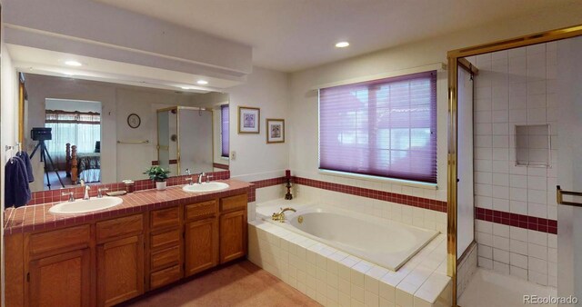 bathroom featuring vanity and plus walk in shower