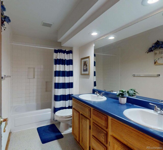 full bathroom featuring vanity, toilet, and shower / tub combo with curtain